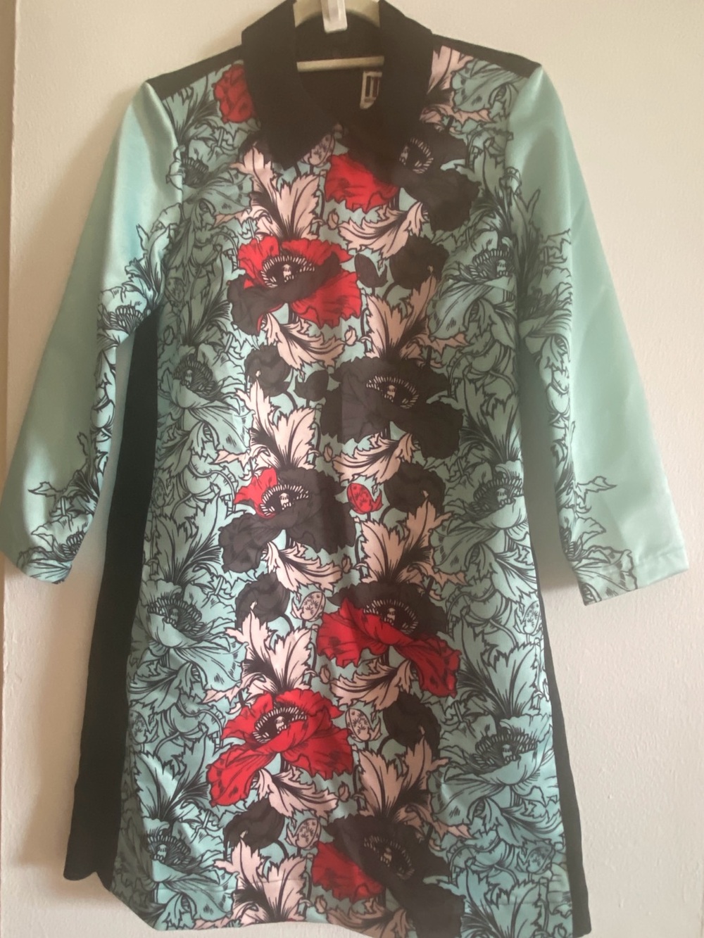 Turquoise Floral Trench Coat with Bold Red Accents
